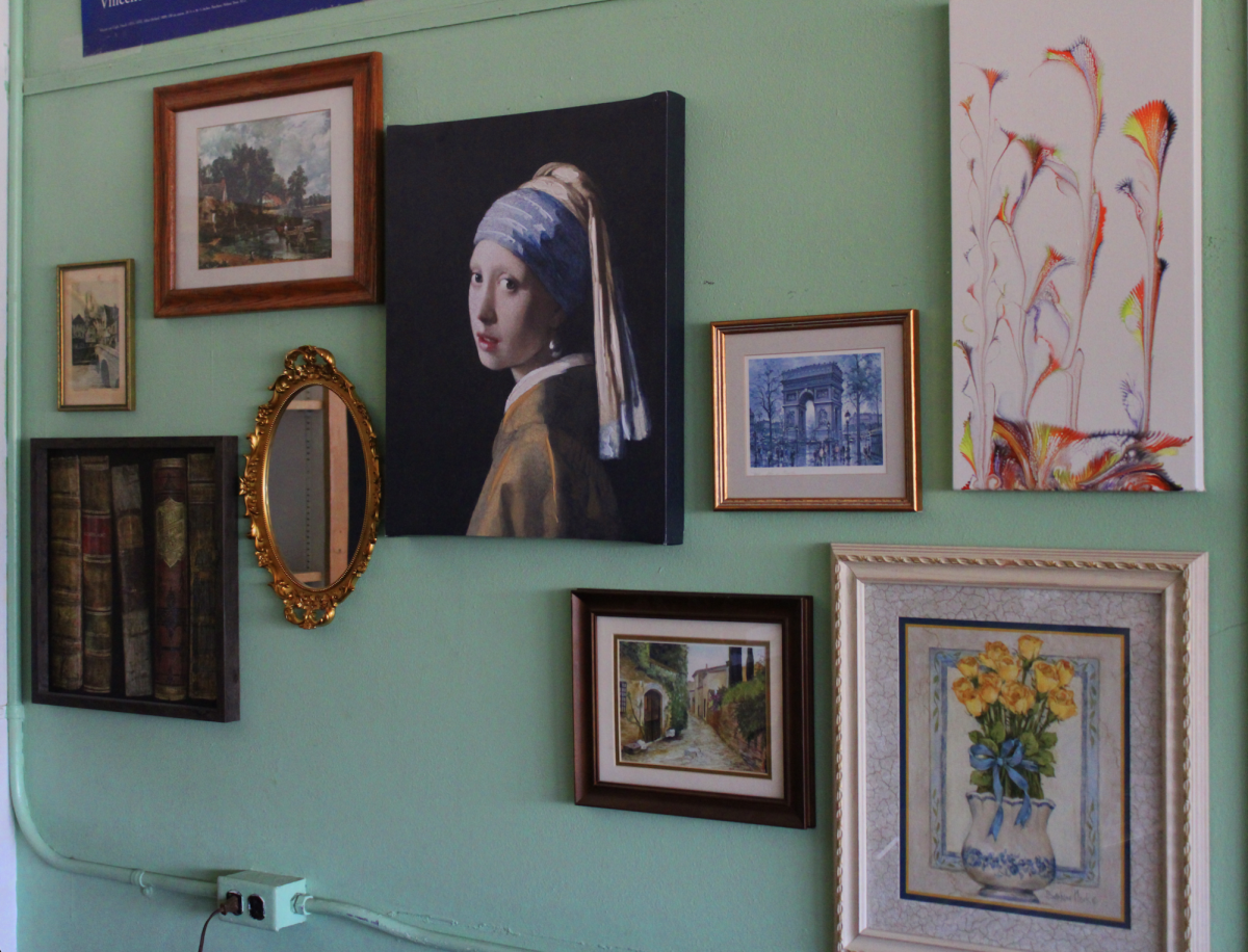 A wall in Sabic's classroom that he has hung art and a mirror on for his students to enjoy. 